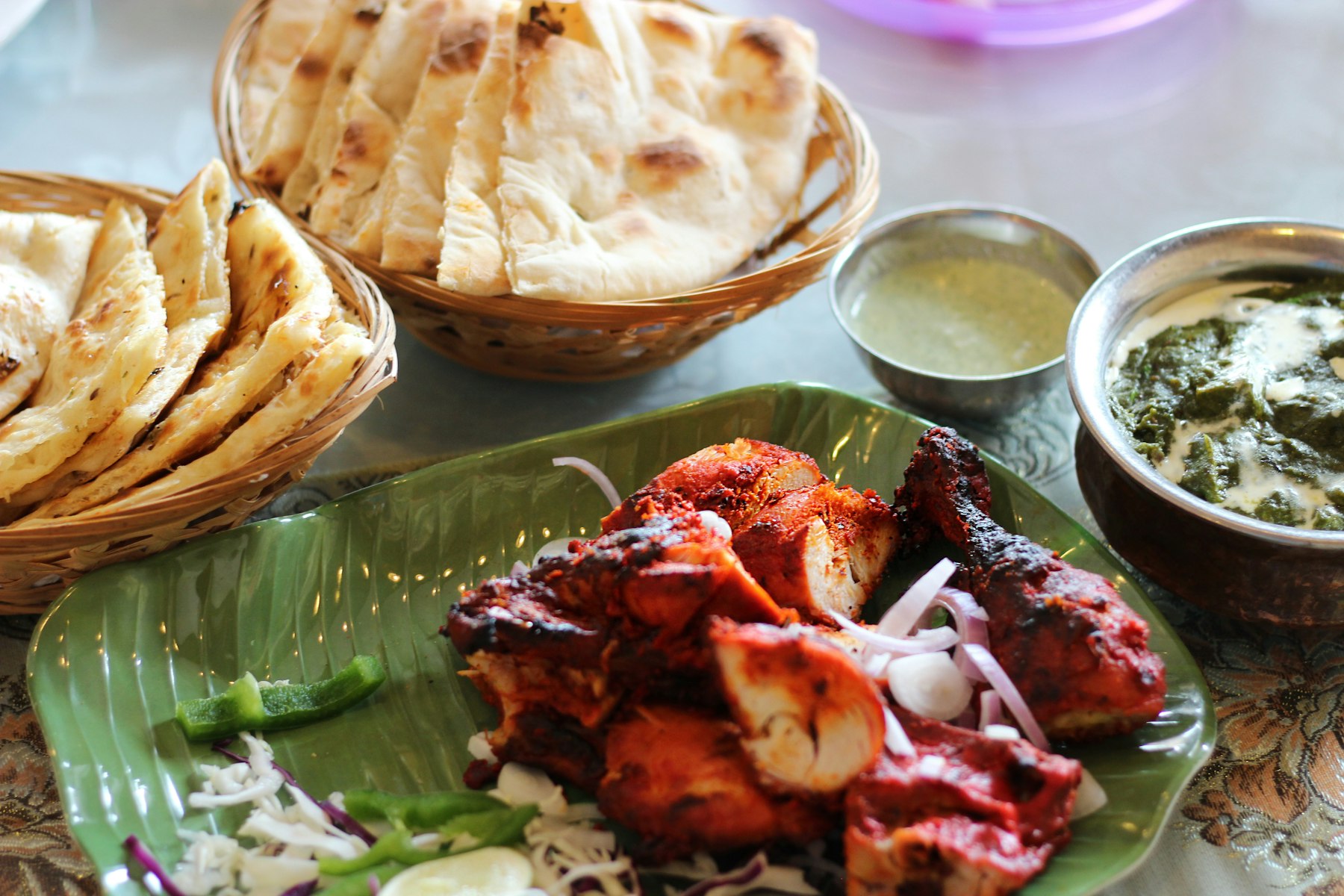 Close-up of tandoori chicken, charred and spiced from the clay oven